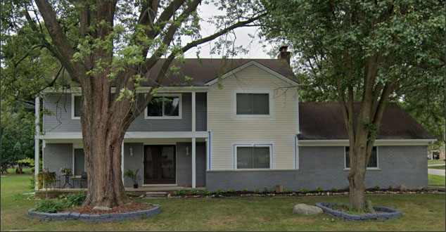 Partial brick house in the process of having brick painted