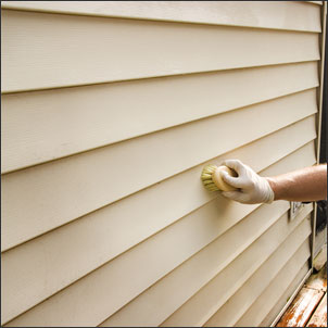 Cleaning vinyl siding with a soft brush